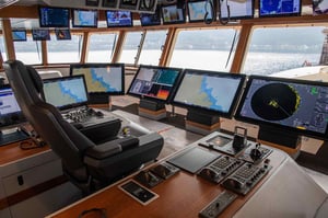 This picture shows a ship bridge with a wide selection of Hatteland Technology monitors, mounted on the floor, from the ceiling, and on a desk. This illustrates the many mounting options you have when it comes to marine monitors.
